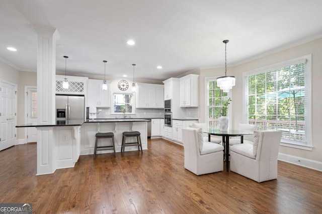 3741 Cape York Trce, Alpharetta, GA 30022 - kitchen with stainless steel fridge with ice dispenser, dark countertops, tasteful backsplash, healthy amount of natural light, and ornamental molding