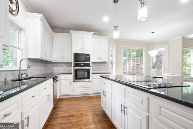 3741 Cape York Trce, Alpharetta, GA 30022 - kitchen with black appliances, white cabinets, crown molding, tasteful backsplash, and recessed lighting
