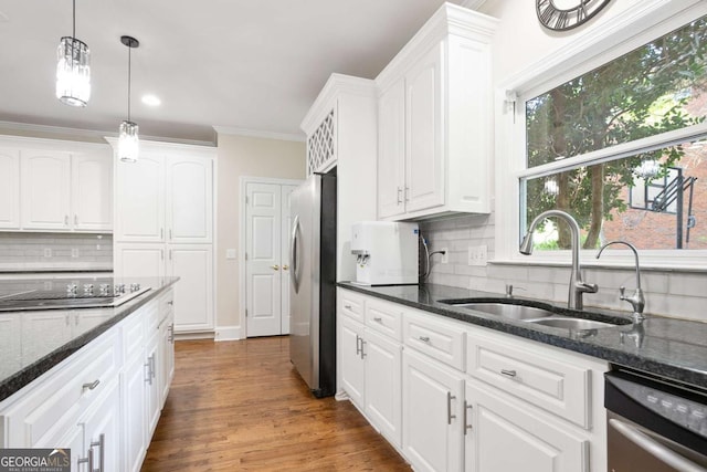 3741 Cape York Trce, Alpharetta, GA 30022 - kitchen with appliances with stainless steel finishes, white cabinetry, decorative backsplash, hanging light fixtures, and crown molding