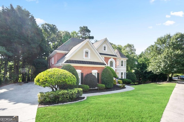 3741 Cape York Trce, Alpharetta, GA 30022 - view of front of home with a standing seam roof, a front yard, a metal roof, brick siding, and stucco siding