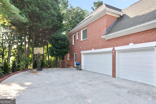 3741 Cape York Trce, Alpharetta, GA 30022 - view of home's exterior featuring driveway, brick siding, and roof with shingles