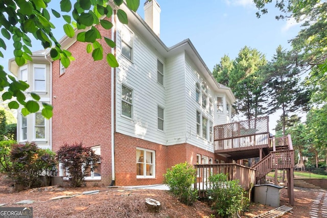 3741 Cape York Trce, Alpharetta, GA 30022 - view of side of home featuring a wooden deck, brick siding, and a chimney
