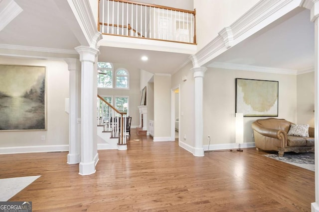 3741 Cape York Trce, Alpharetta, GA 30022 - entryway with wood finished floors, stairs, decorative columns, ornamental molding, and a towering ceiling