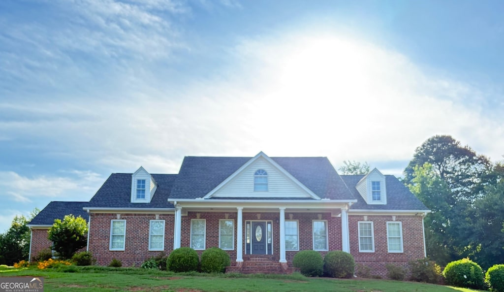 1681 Jett Roberts Rd, Jefferson, GA 30549 - view of front of property with brick siding, a front lawn, and a porch