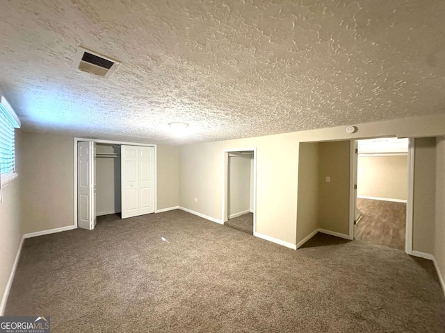 3456 Spring Cir, Decatur, GA 30032 - unfurnished bedroom featuring a textured ceiling, carpet, and baseboards
