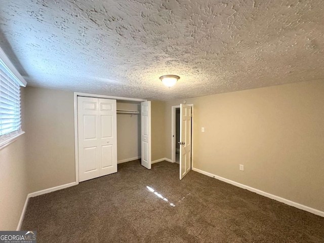 3456 Spring Cir, Decatur, GA 30032 - unfurnished bedroom with dark carpet, a textured ceiling, a closet, and baseboards
