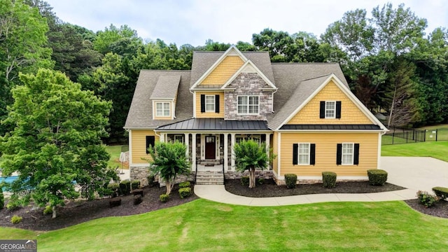 116 Archstone Sq, Mcdonough, GA 30253 - craftsman-style home featuring a standing seam roof, covered porch, stone siding, and a shingled roof