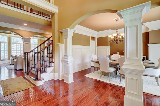 116 Archstone Sq, Mcdonough, GA 30253 - dining area with arched walkways, wood finished floors, decorative columns, stairs, and crown molding
