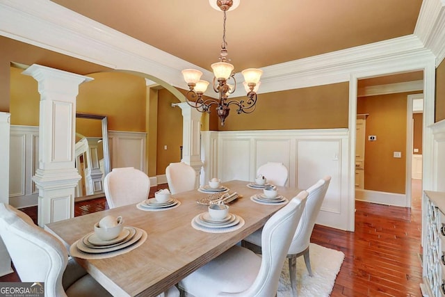 116 Archstone Sq, Mcdonough, GA 30253 - dining room with arched walkways, a decorative wall, wood-type flooring, a chandelier, and a wainscoted wall