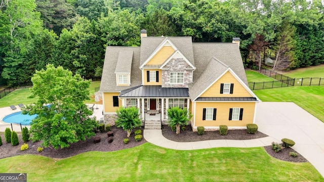 116 Archstone Sq, Mcdonough, GA 30253 - craftsman-style home with a chimney, a standing seam roof, stone siding, and covered porch