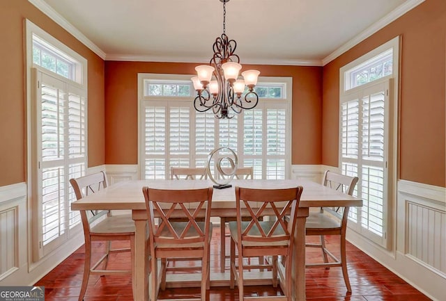 116 Archstone Sq, Mcdonough, GA 30253 - dining area featuring plenty of natural light, a wainscoted wall, a decorative wall, dark wood-type flooring, and a chandelier