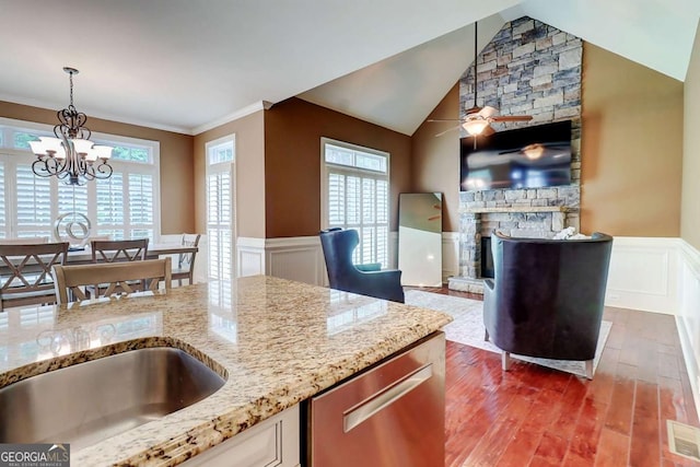 116 Archstone Sq, Mcdonough, GA 30253 - kitchen featuring stainless steel dishwasher, wood finished floors, wainscoting, healthy amount of natural light, and a chandelier