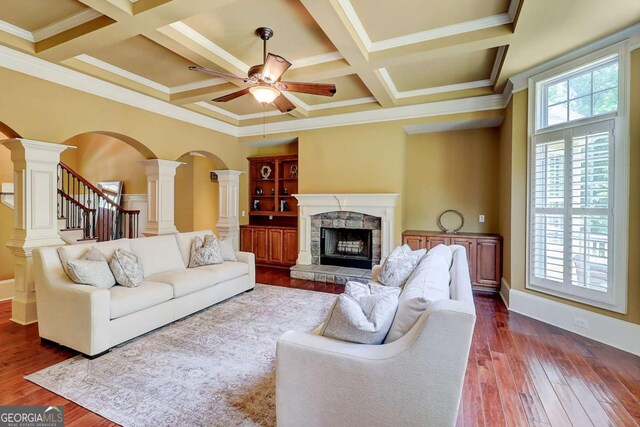 116 Archstone Sq, Mcdonough, GA 30253 - living room with ornate columns, arched walkways, a ceiling fan, dark wood finished floors, and coffered ceiling