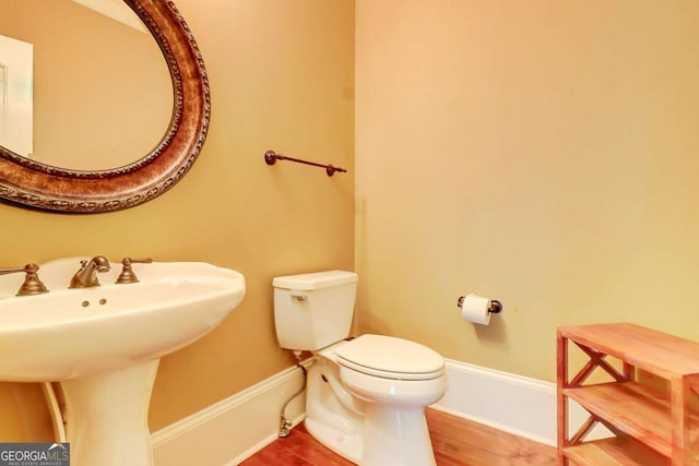 116 Archstone Sq, Mcdonough, GA 30253 - half bathroom featuring a sink and wood finished floors