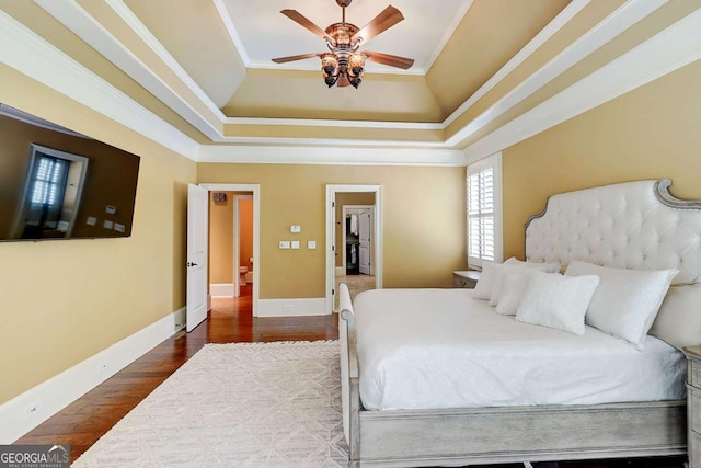 116 Archstone Sq, Mcdonough, GA 30253 - bedroom with a raised ceiling, dark wood-style flooring, ornamental molding, and a ceiling fan