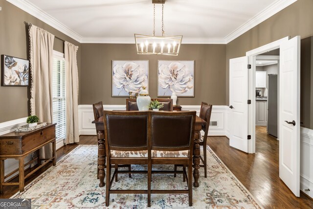 10530 Tuxford Dr, Alpharetta, GA 30022 - dining space with a chandelier, ornamental molding, dark wood-style flooring, and wainscoting
