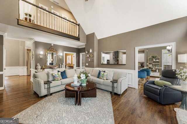 10530 Tuxford Dr, Alpharetta, GA 30022 - living area featuring high vaulted ceiling, wood finished floors, a wainscoted wall, and a decorative wall