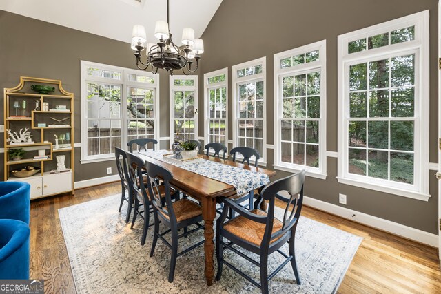 10530 Tuxford Dr, Alpharetta, GA 30022 - dining room featuring a chandelier, plenty of natural light, wood finished floors, and high vaulted ceiling