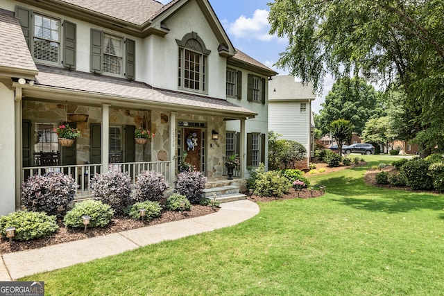 10530 Tuxford Dr, Alpharetta, GA 30022 - view of front of house featuring roof with shingles, a front yard, and stone siding