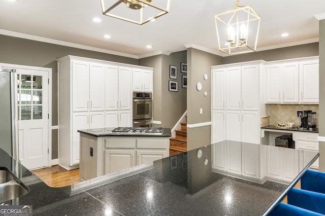 10530 Tuxford Dr, Alpharetta, GA 30022 - kitchen with a kitchen island, recessed lighting, decorative backsplash, white cabinets, and ornamental molding