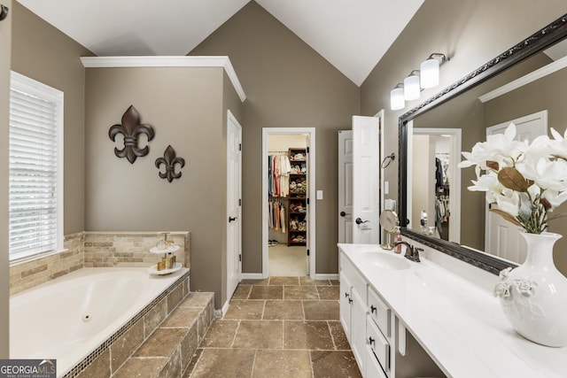 10530 Tuxford Dr, Alpharetta, GA 30022 - full bath featuring a garden tub, vanity, a spacious closet, stone tile floors, and lofted ceiling