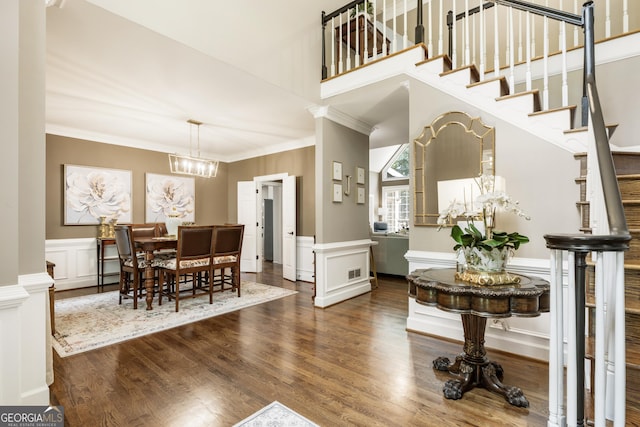 10530 Tuxford Dr, Alpharetta, GA 30022 - dining space with a decorative wall, crown molding, wood finished floors, a chandelier, and a wainscoted wall