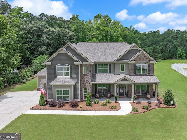 29 Peppertree Dr, Newnan, GA 30265 - craftsman-style home featuring a porch, driveway, a front yard, and roof with shingles