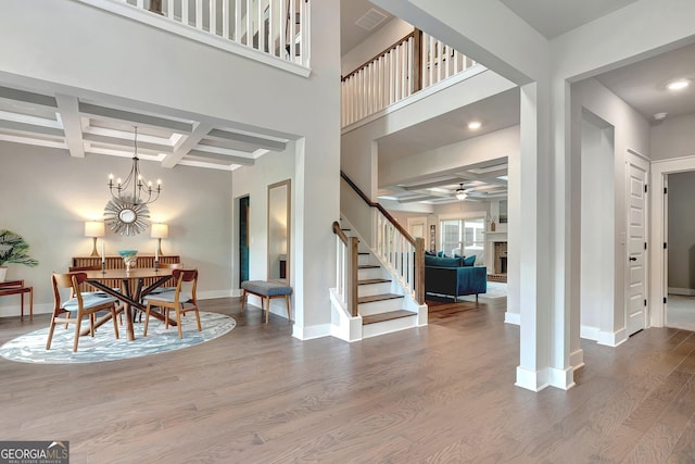 29 Peppertree Dr, Newnan, GA 30265 - foyer with coffered ceiling, wood finished floors, stairs, ceiling fan, and beam ceiling