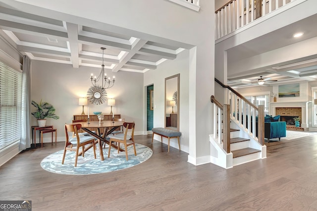 29 Peppertree Dr, Newnan, GA 30265 - dining room featuring coffered ceiling, stairs, beamed ceiling, wood finished floors, and ceiling fan