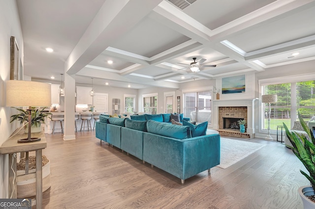 29 Peppertree Dr, Newnan, GA 30265 - living room with light wood finished floors, a ceiling fan, beamed ceiling, a fireplace, and coffered ceiling