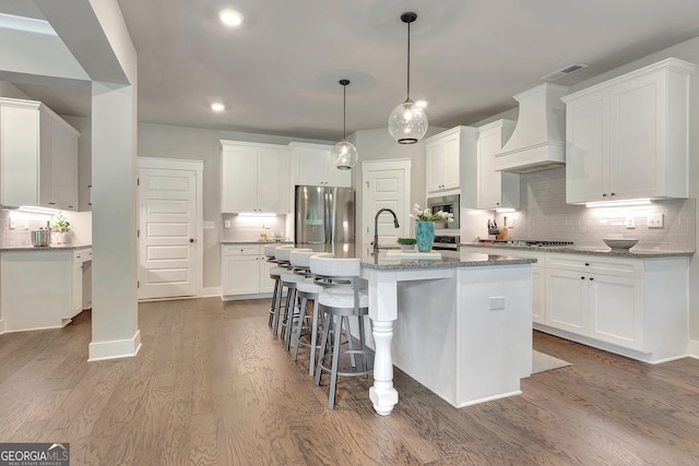 29 Peppertree Dr, Newnan, GA 30265 - kitchen featuring premium range hood, stainless steel appliances, backsplash, wood finished floors, and recessed lighting