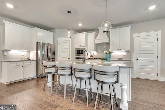 29 Peppertree Dr, Newnan, GA 30265 - kitchen with appliances with stainless steel finishes, wood finished floors, decorative backsplash, white cabinets, and recessed lighting