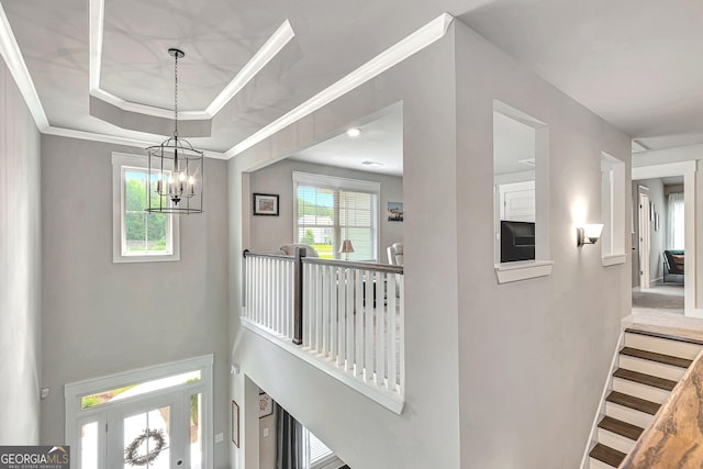 29 Peppertree Dr, Newnan, GA 30265 - corridor with a chandelier, a tray ceiling, and crown molding