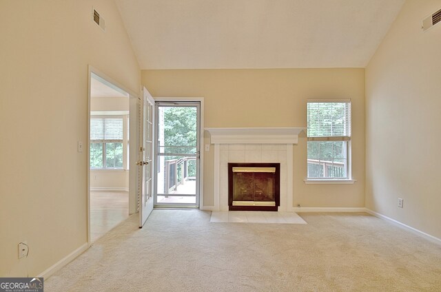 4135 Coursey Lake Rd, Douglasville, GA 30135 - unfurnished living room featuring lofted ceiling, carpet flooring, plenty of natural light, and a fireplace