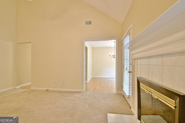4135 Coursey Lake Rd, Douglasville, GA 30135 - unfurnished living room featuring carpet flooring, a chandelier, and high vaulted ceiling
