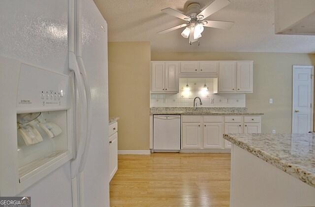 4135 Coursey Lake Rd, Douglasville, GA 30135 - kitchen featuring white appliances, ceiling fan, light wood-style flooring, white cabinets, and a textured ceiling