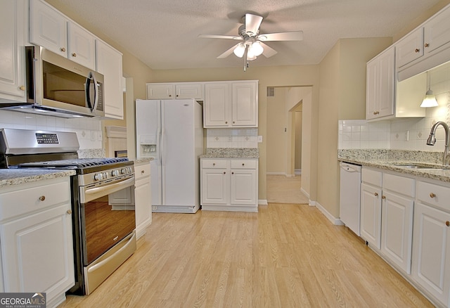 4135 Coursey Lake Rd, Douglasville, GA 30135 - kitchen with stainless steel appliances, tasteful backsplash, a ceiling fan, white cabinets, and a textured ceiling