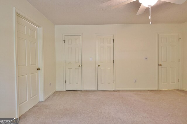 4135 Coursey Lake Rd, Douglasville, GA 30135 - unfurnished bedroom featuring light carpet, a ceiling fan, and a textured ceiling