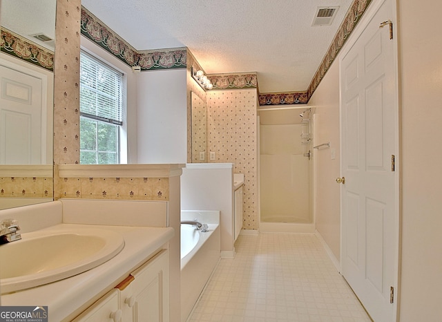 4135 Coursey Lake Rd, Douglasville, GA 30135 - bathroom featuring a shower stall, a textured ceiling, a garden tub, tile patterned floors, and vanity