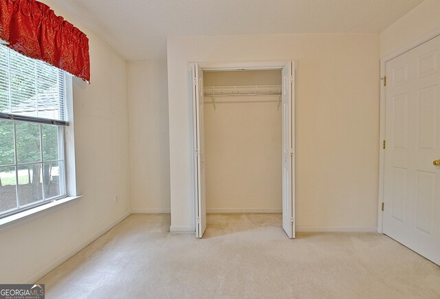 4135 Coursey Lake Rd, Douglasville, GA 30135 - unfurnished bedroom with light colored carpet and a closet