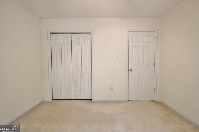 4135 Coursey Lake Rd, Douglasville, GA 30135 - unfurnished bedroom featuring light colored carpet and a closet