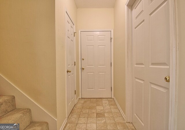 4135 Coursey Lake Rd, Douglasville, GA 30135 - entryway featuring light stone finish floors, stairs, and a textured ceiling
