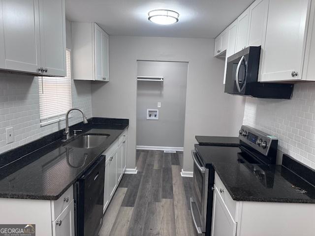 207 Custer Cir, Griffin, GA 30223 - kitchen with stainless steel range with electric cooktop, dishwasher, decorative backsplash, and dark wood-style floors