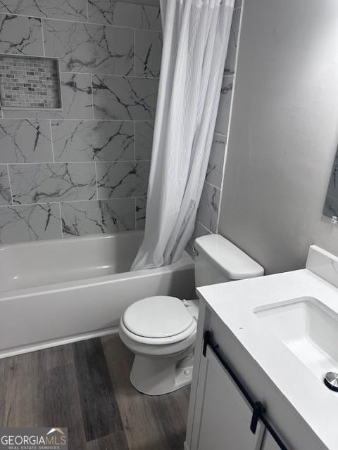207 Custer Cir, Griffin, GA 30223 - bathroom with vanity, shower / bathtub combination with curtain, and wood finished floors