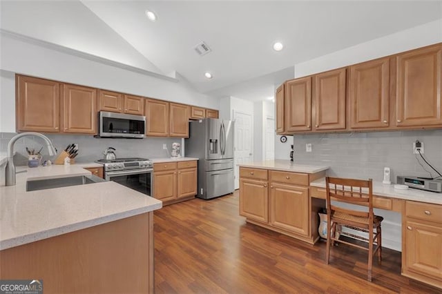 1402 Silver Smt, Conyers, GA 30094 - kitchen with appliances with stainless steel finishes, built in study area, decorative backsplash, light stone countertops, and dark wood finished floors