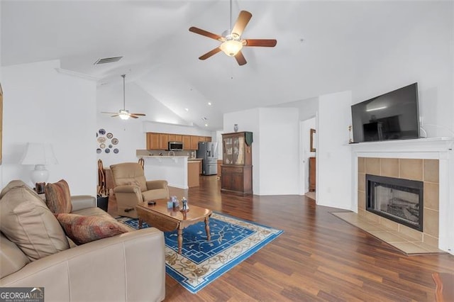 1402 Silver Smt, Conyers, GA 30094 - living area featuring ceiling fan, dark wood-style floors, a tile fireplace, and high vaulted ceiling