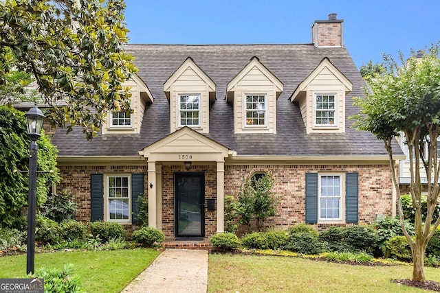 1508 Brianwood Rd Unit 1508, Decatur, GA 30033 - cape cod house featuring brick siding, a front yard, a chimney, and roof with shingles