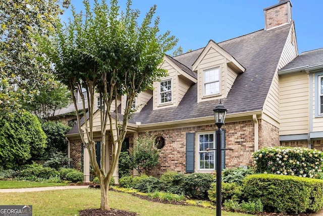 1508 Brianwood Rd Unit 1508, Decatur, GA 30033 - cape cod home featuring brick siding, a chimney, roof with shingles, and a front yard