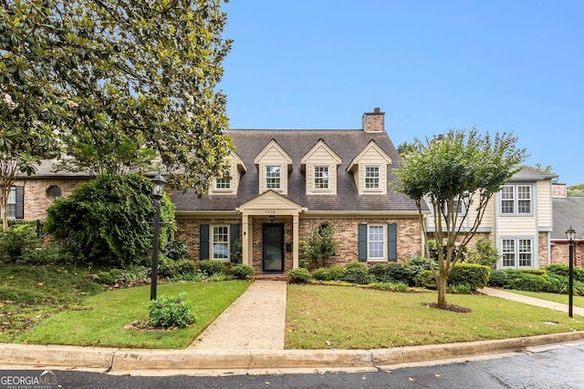 1508 Brianwood Rd Unit 1508, Decatur, GA 30033 - cape cod house featuring brick siding, a chimney, a front lawn, and roof with shingles