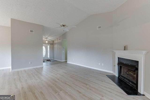 4735 Widgeon Way, Cumming, GA 30028 - unfurnished living room with ceiling fan, a fireplace with raised hearth, light wood-style flooring, high vaulted ceiling, and a textured ceiling